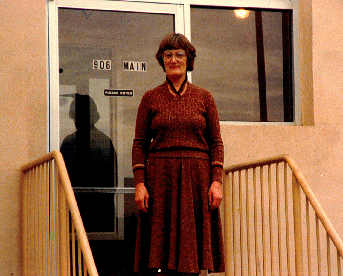 A Triage employee standing on front steps of the first Triage Shelter